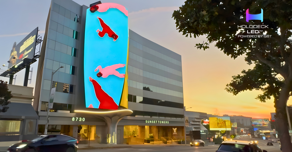 Curved LED billboard on the corner of 8730 Sunset Towers displaying pop-art swimmers, with Sunset Boulevard traffic at dusk