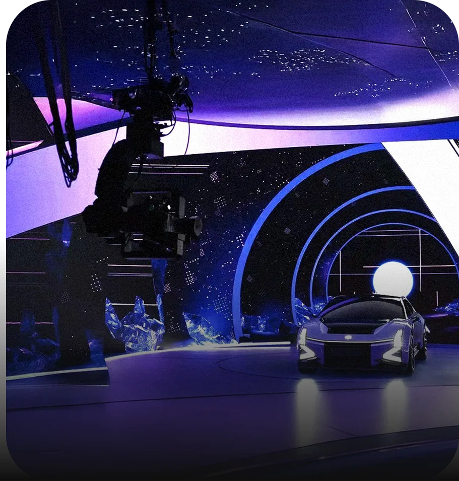 Car on a virtual production stage surrounded by curved LED walls showing a starfield, with a camera rig overhead