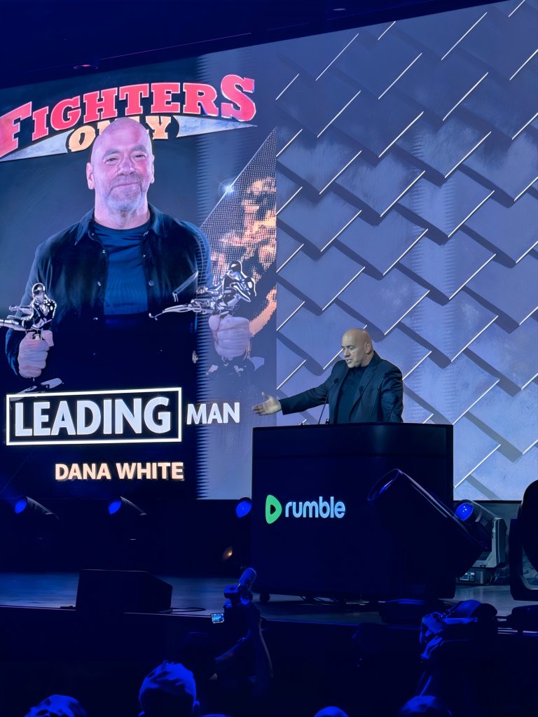 Dana White accepts the "Leading Man" award at the HOLODECK HoloPod™ podium, branded for Rumble, 17th World MMA Awards