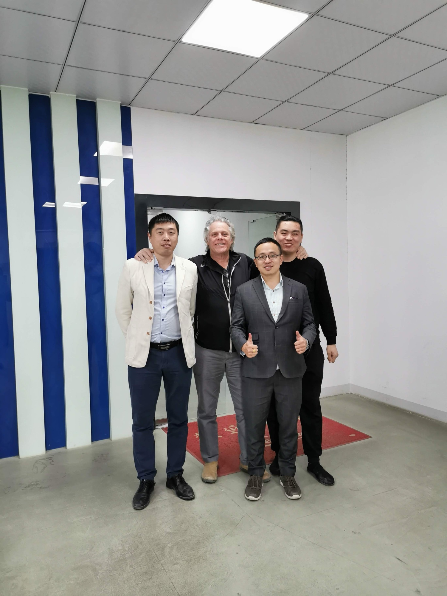 John Hu and Brian Evans with the Zhang brothers at the Guangming assembly facility