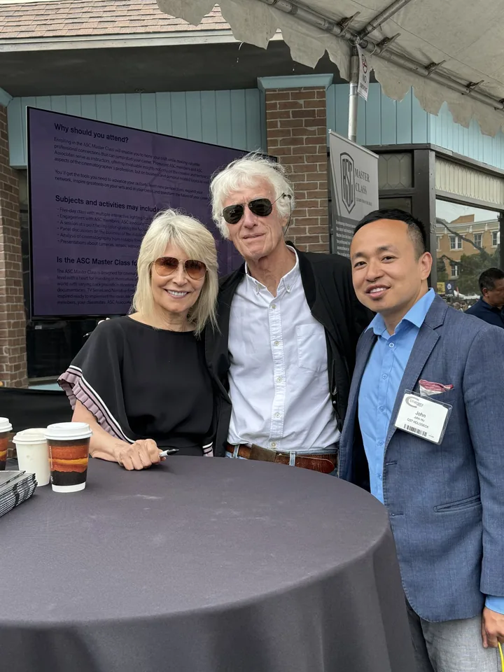 Three people at an outdoor cocktail table