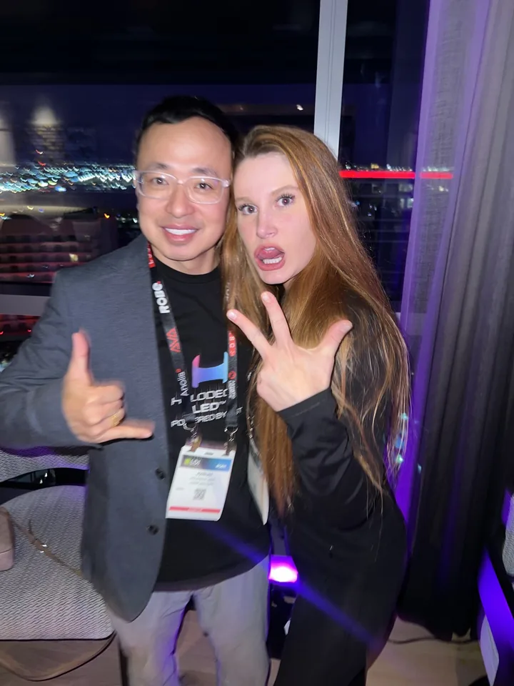 Two event attendees giving hand signs