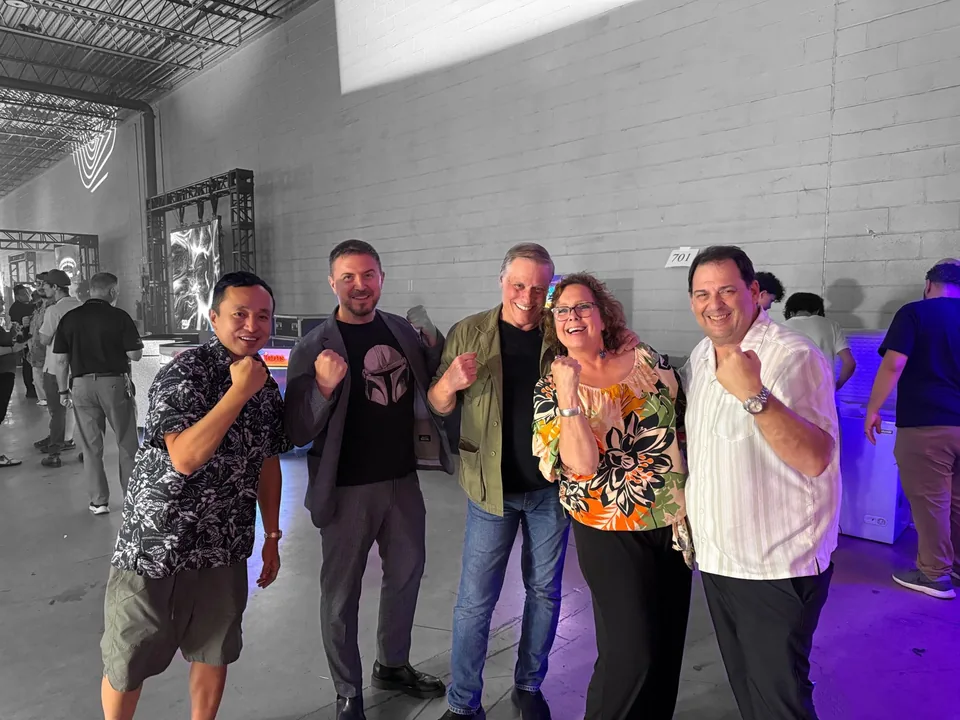 Five event attendees posing together