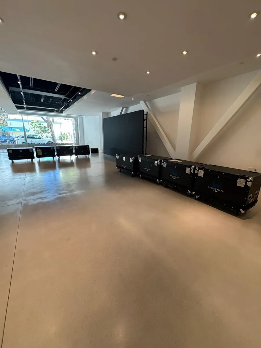 Empty HOLODECK LED showroom floor with black HOLODECK LED flight cases and the LED wall in the background